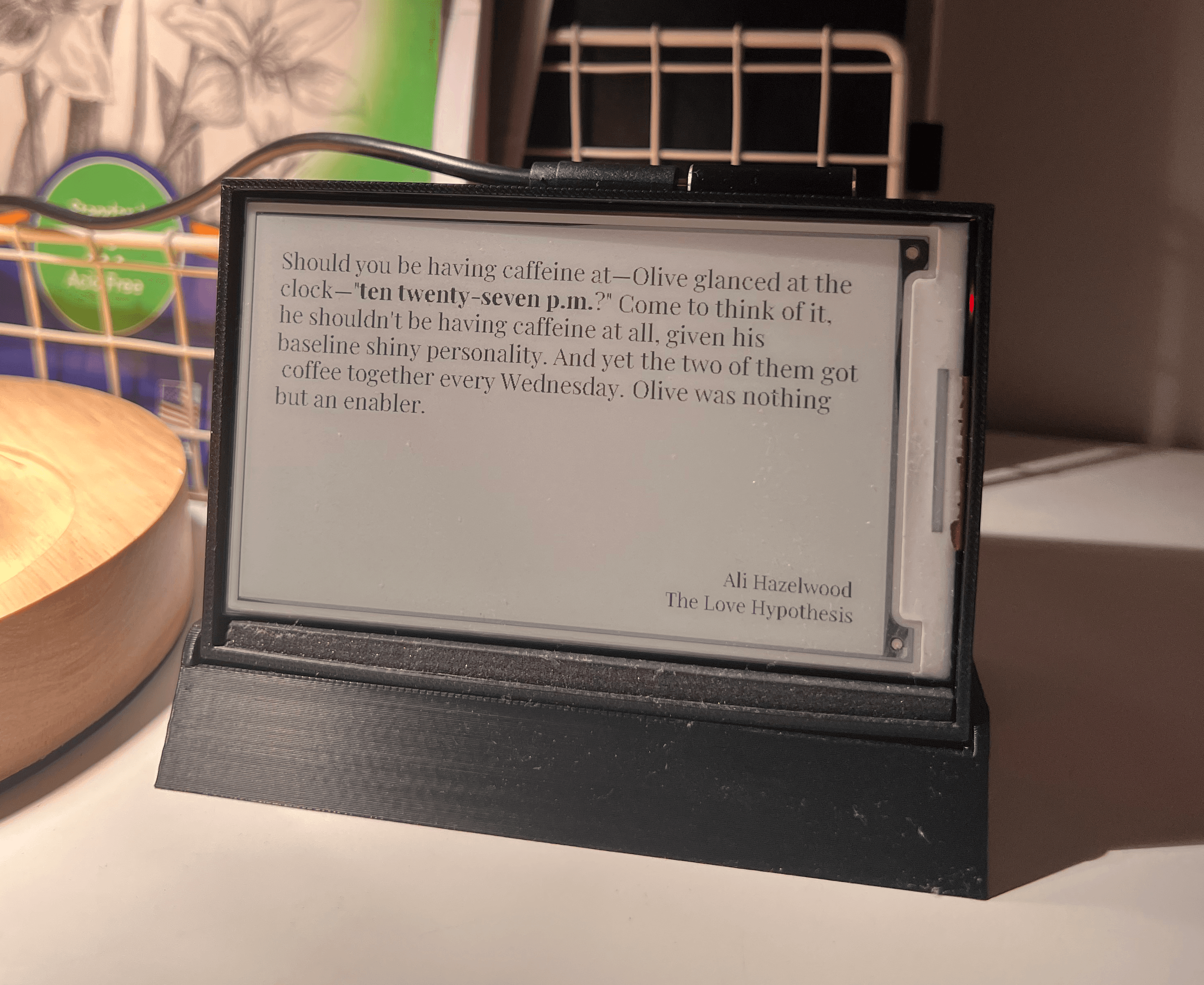 A homemade literary clock displaying a book quote on an e-ink screen